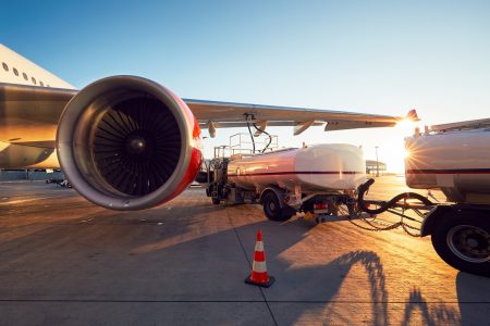 Amazing sunset at the airport. Refueling of the airplane before flight.